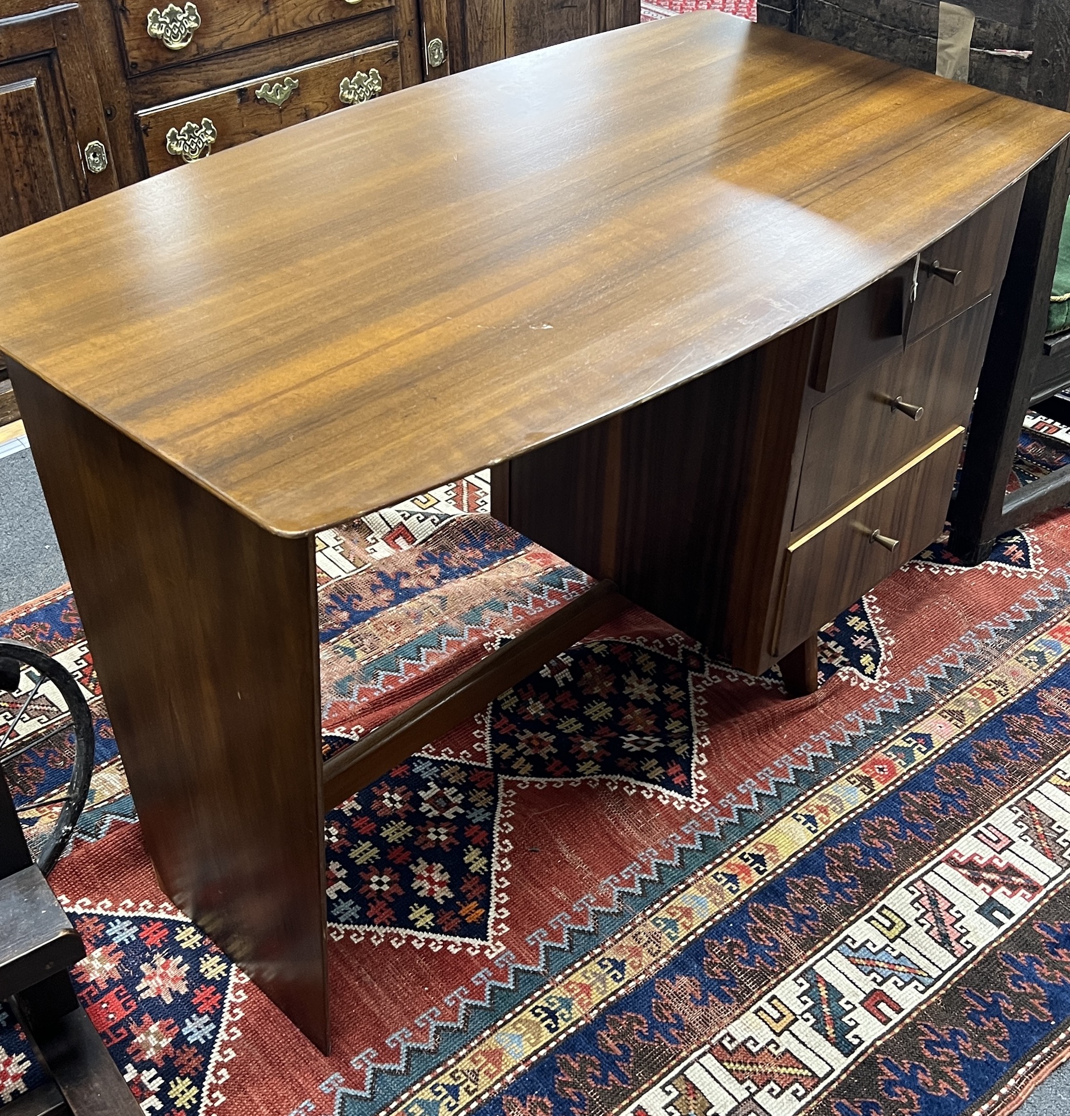 A mid century walnut desk, width 108cm, depth 64cm, height 75cm